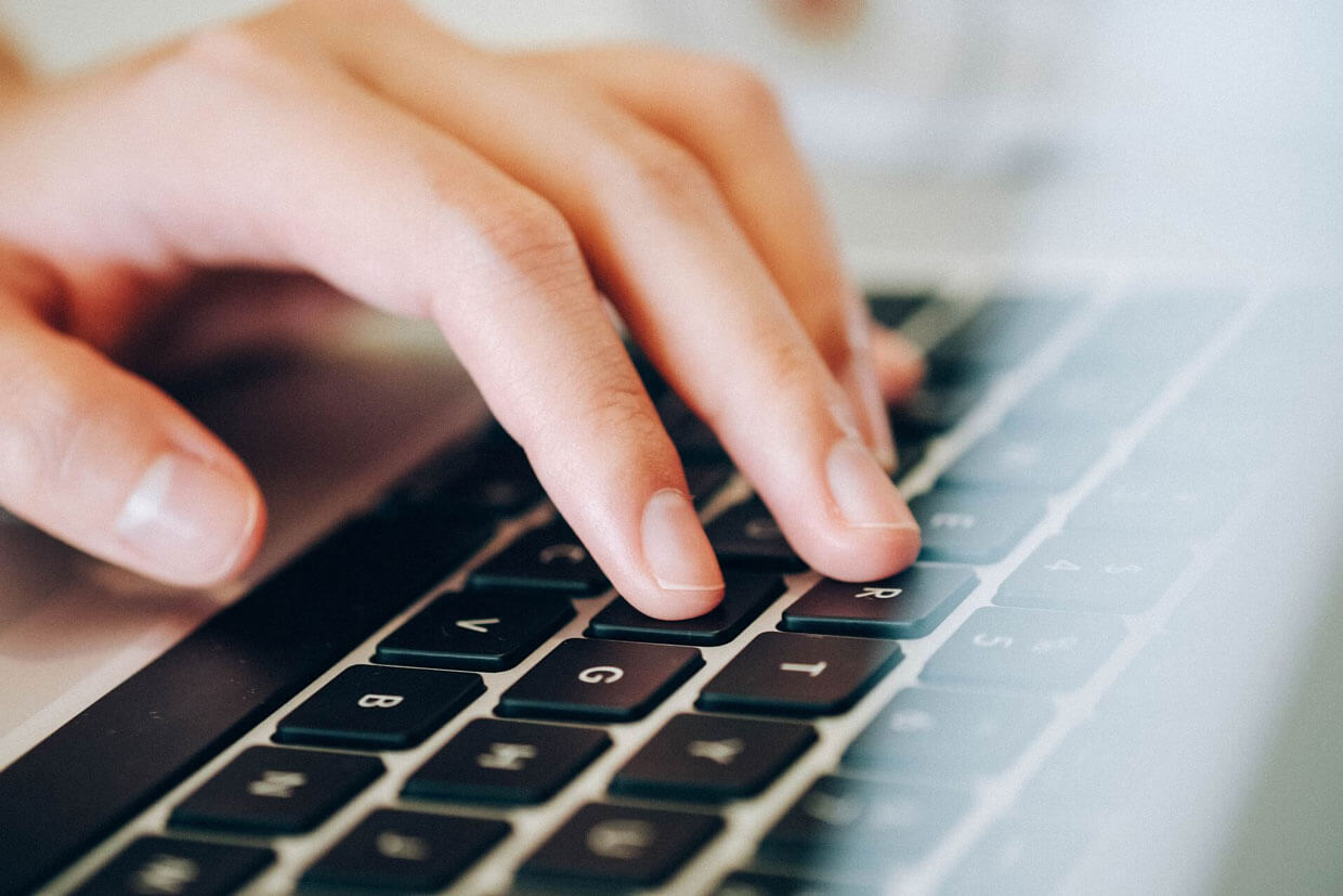 person typing on keyboard