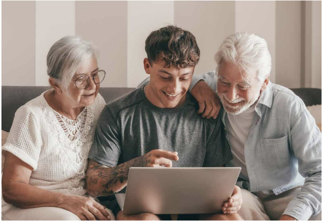 Young man helping older people not be scammed using laptop